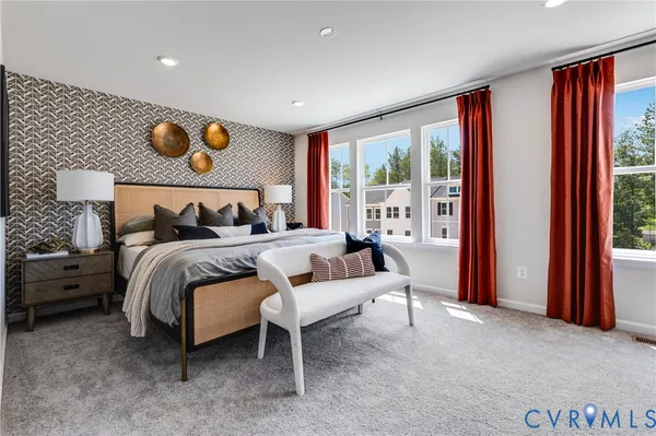 a bedroom with a bed and painting on the wall