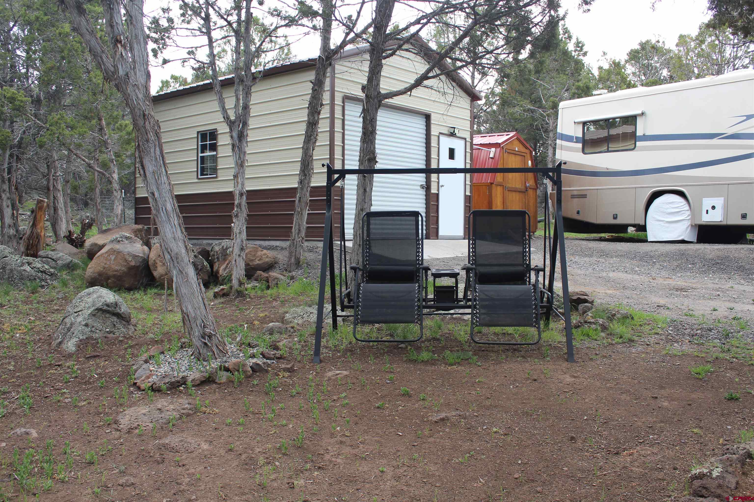 21051 Brimstone Road Cedaredge, CO 81413 - Photo 15 of 25 a front view of a house with garden