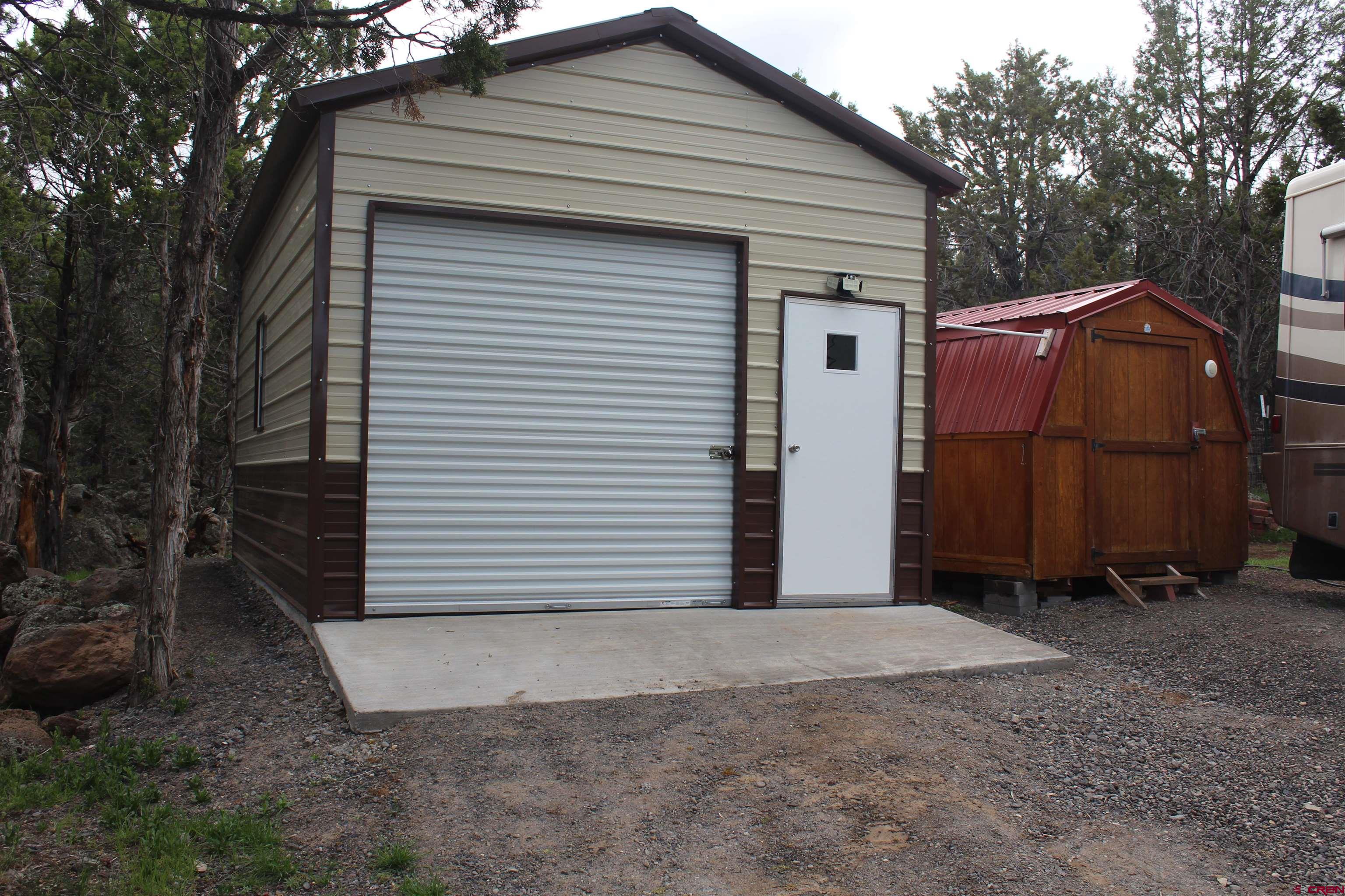 21051 Brimstone Road Cedaredge, CO 81413 - Photo 16 of 25 a view of a small house with wooden fence