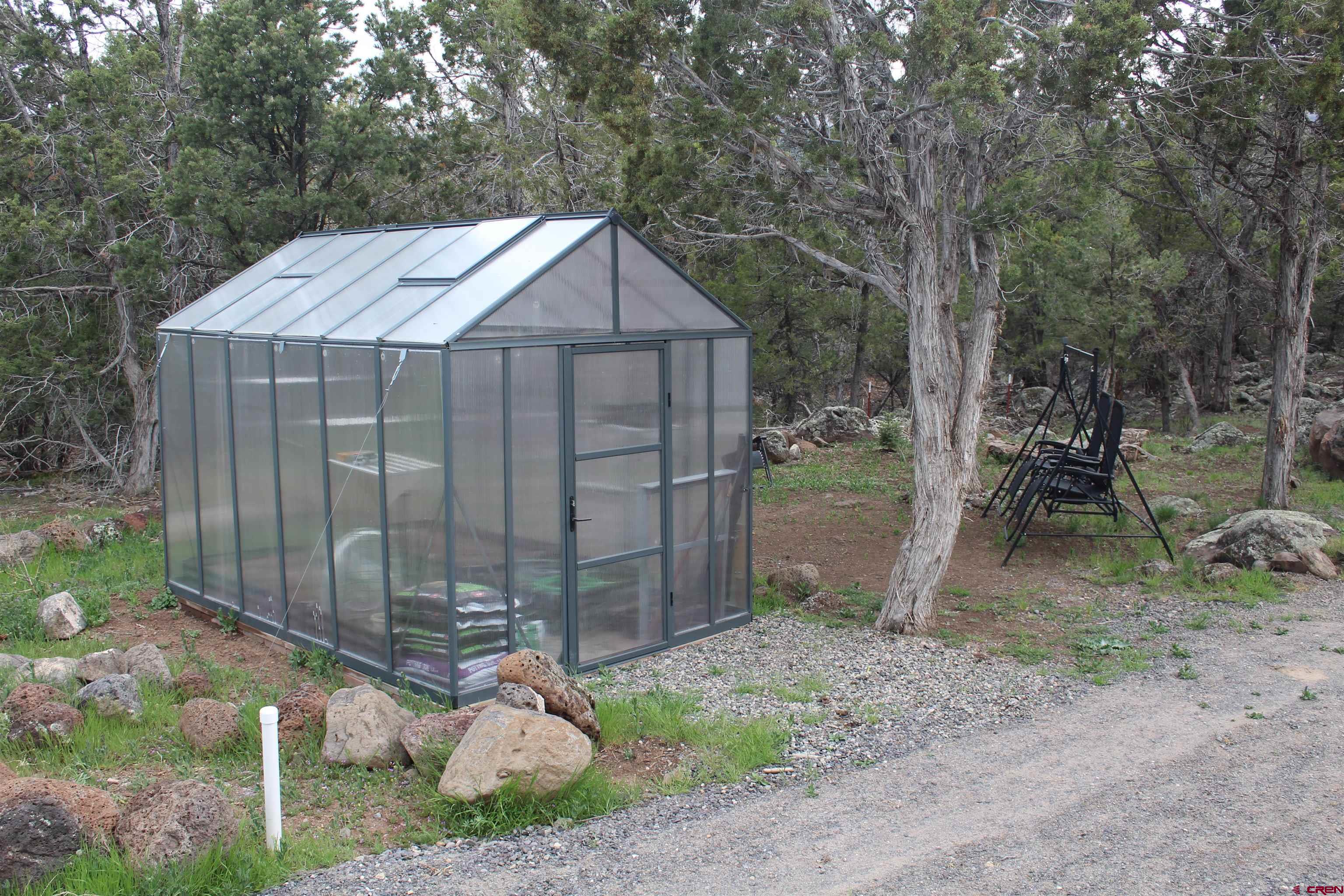 21051 Brimstone Road Cedaredge, CO 81413 - Photo 17 of 25 a backyard of a house with lots of green space