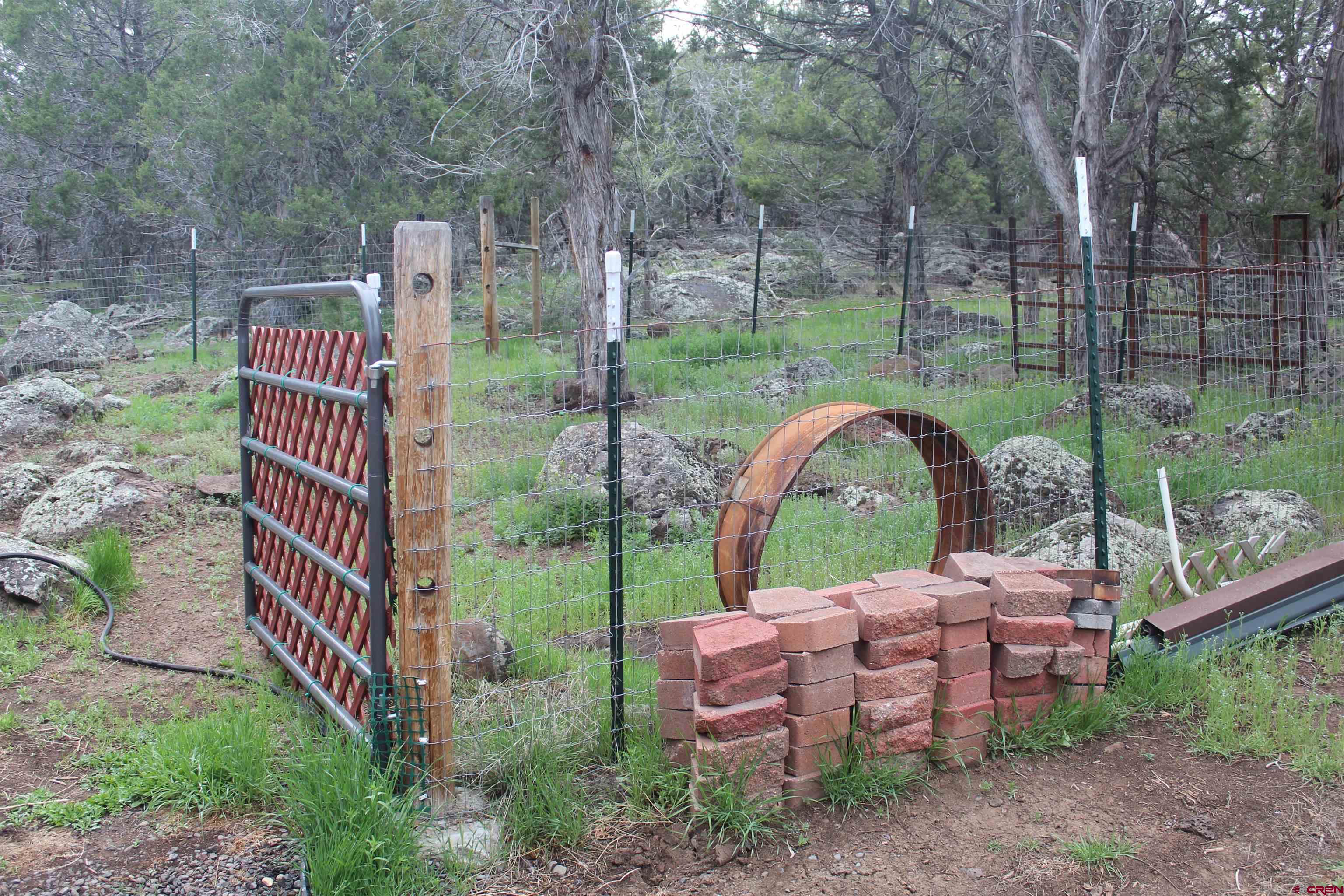 21051 Brimstone Road Cedaredge, CO 81413 - Photo 18 of 25 a backyard of a house with table and chairs