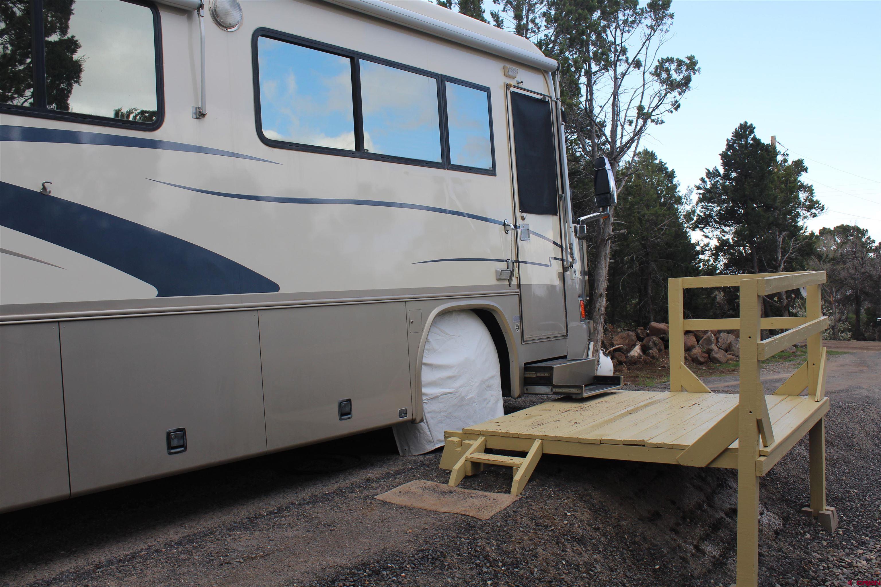 21051 Brimstone Road Cedaredge, CO 81413 - Photo 21 of 25 a backyard of a house with table and chairs