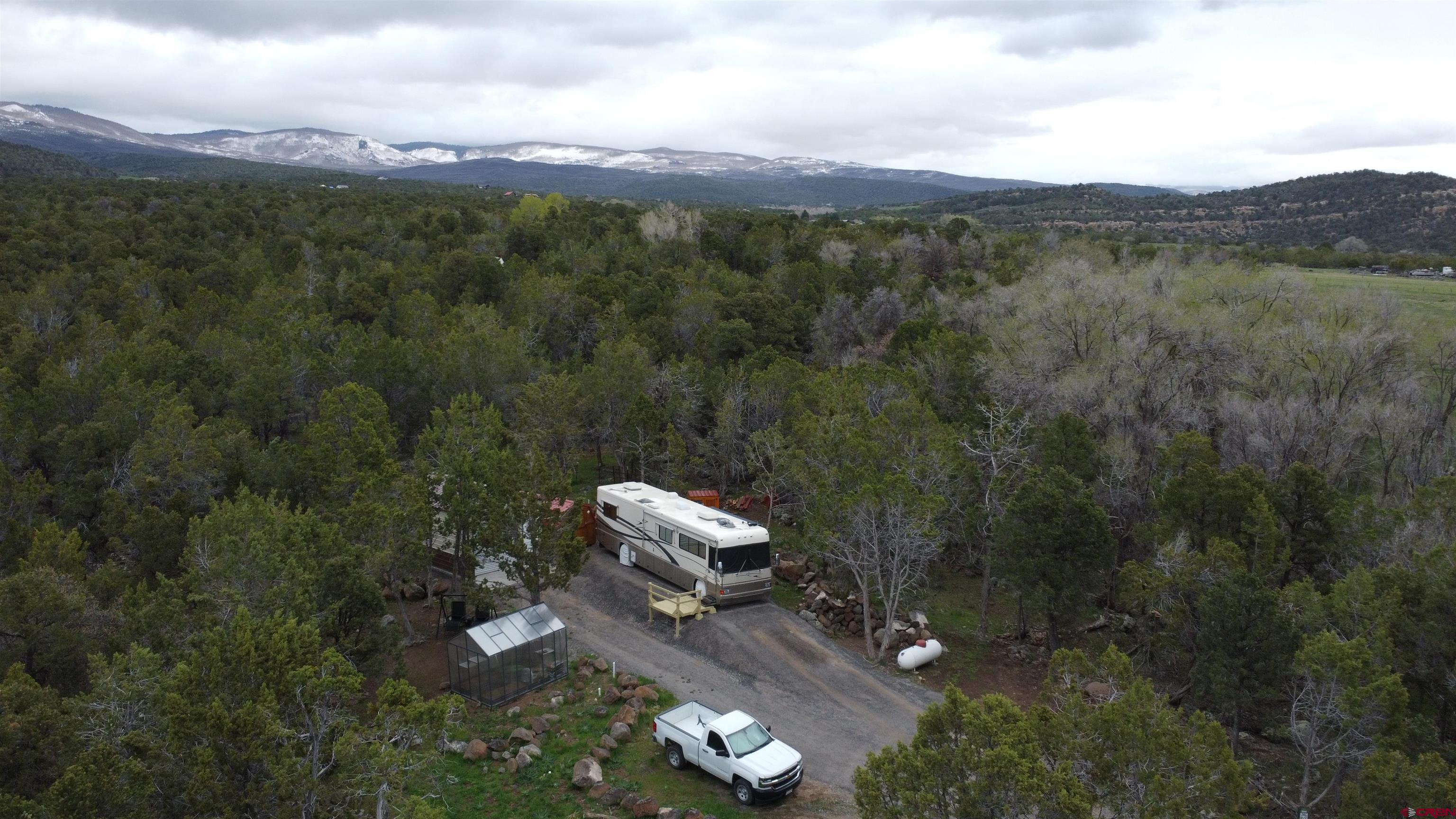 21051 Brimstone Road Cedaredge, CO 81413 - Photo 24 of 25 a view of a city with lush green forest