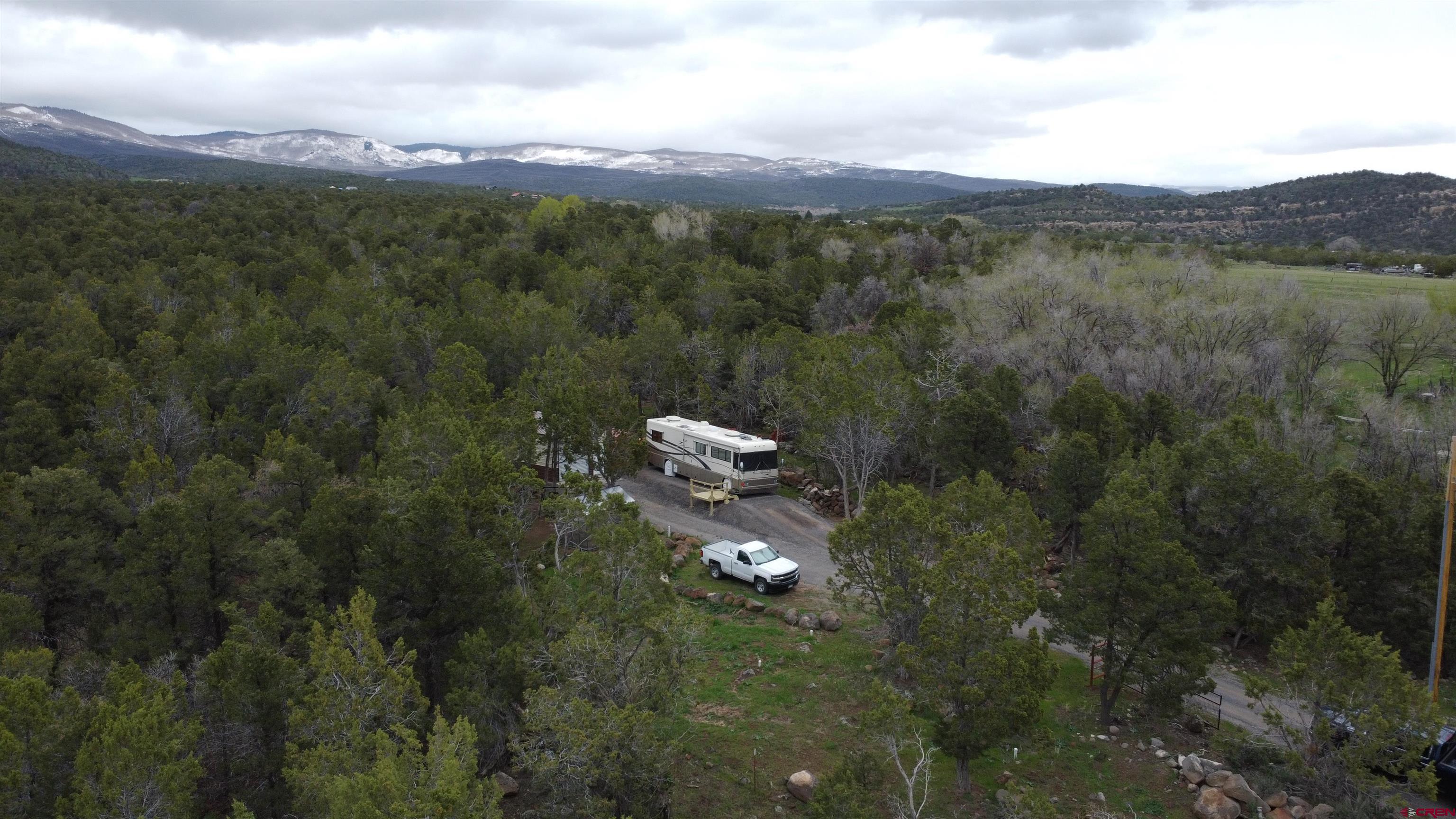 21051 Brimstone Road Cedaredge, CO 81413 - Photo 4 of 25 a backyard of a house with lots of green space