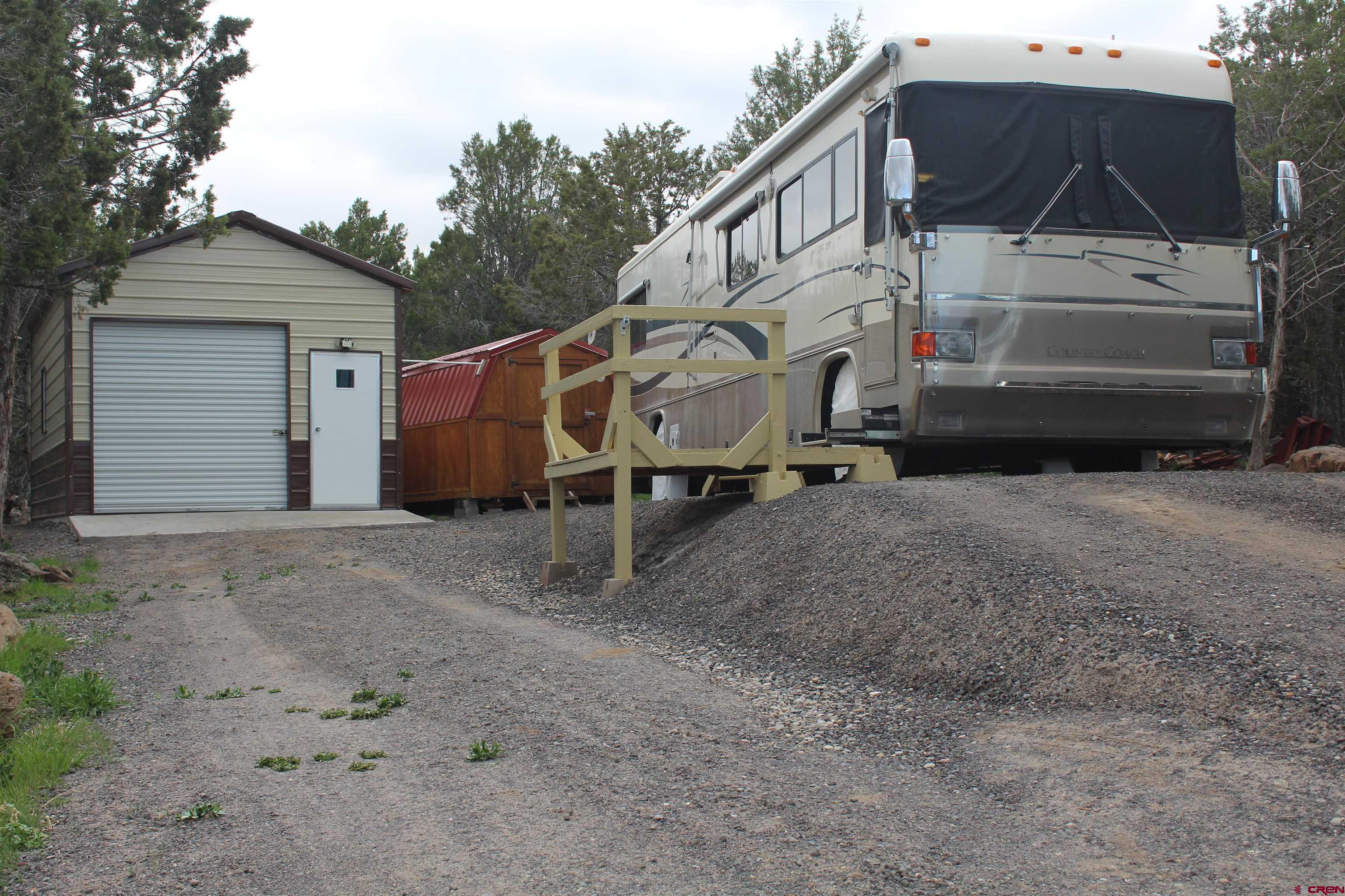 21051 Brimstone Road Cedaredge, CO 81413 - Photo 6 of 25 a house with trees in the background