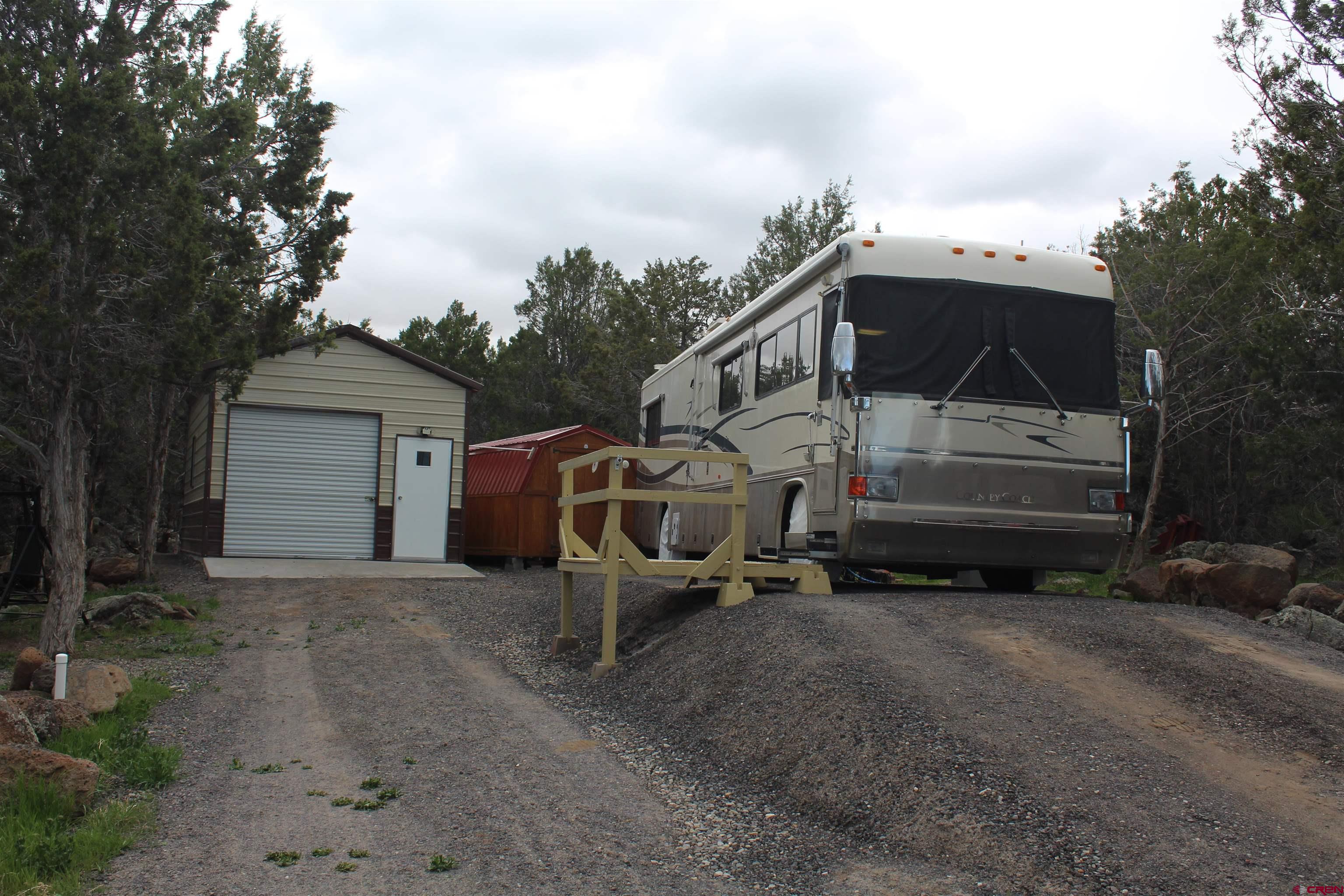 21051 Brimstone Road Cedaredge, CO 81413 - Photo 7 of 25 a front view of a house with a yard