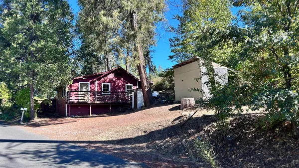 a wooden bench sitting in front of a house