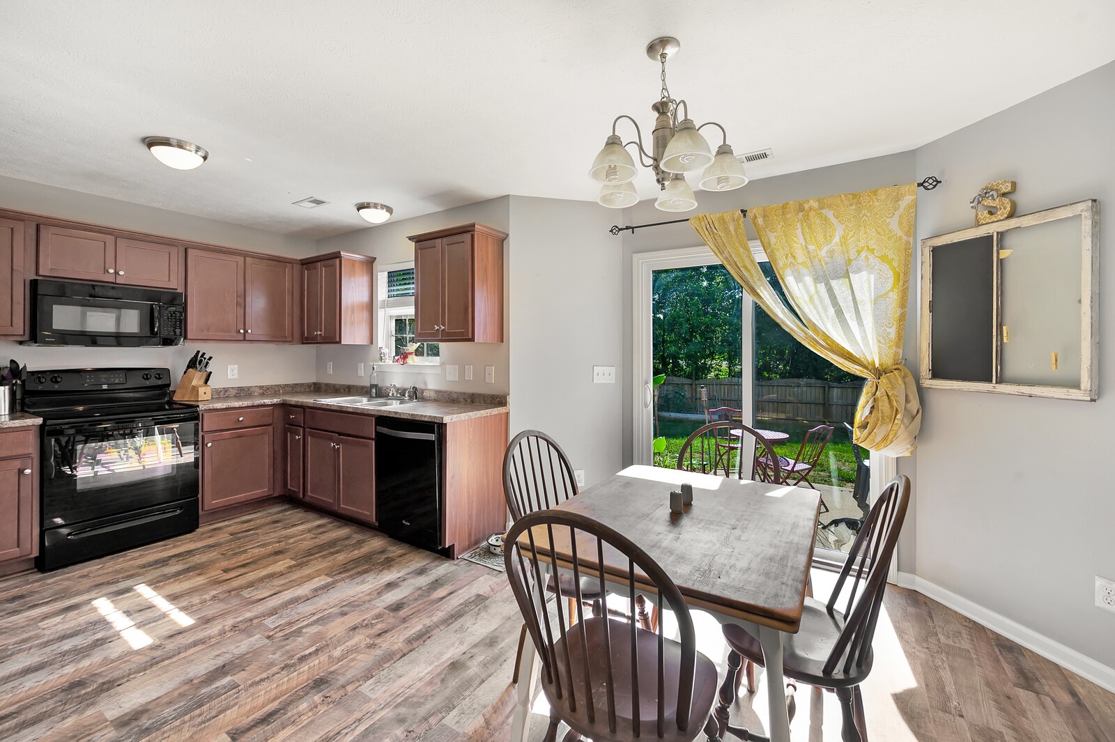 1129 Woodall Road Lebanon, TN 37090 - Photo 6 of 12 a kitchen with a table chairs microwave and cabinets