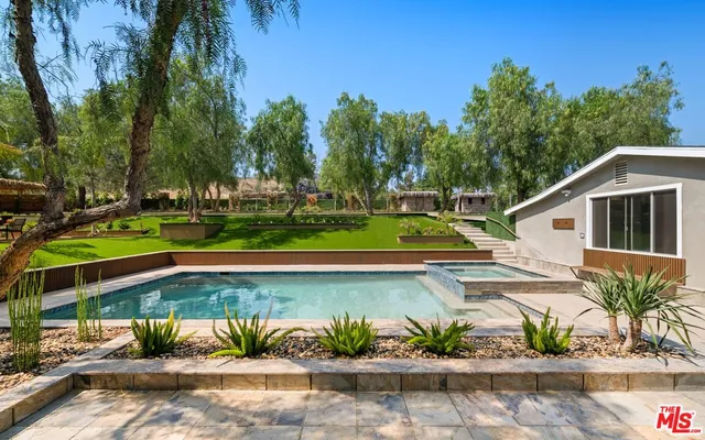 a view of a house with a yard and a garden