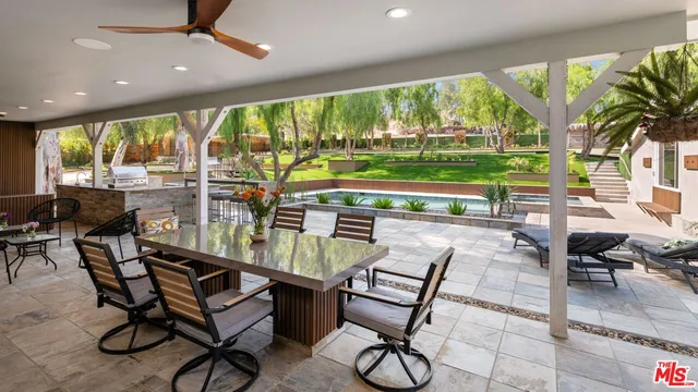 a dining room with furniture a garden and patio