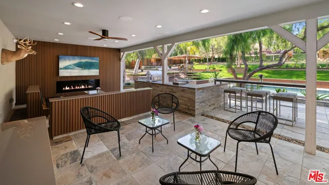 a dining room with furniture a floor to ceiling window and floor to ceiling windows