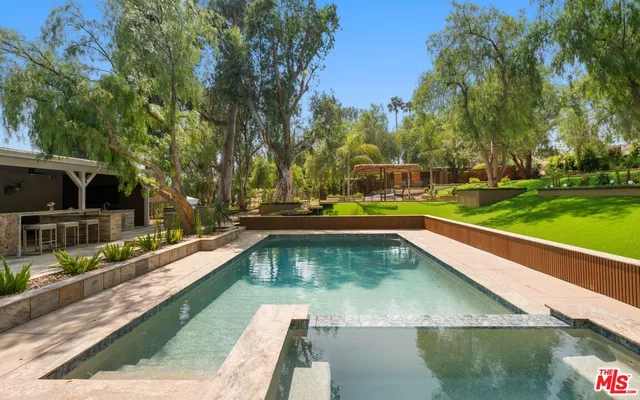 a view of a swimming pool with a patio