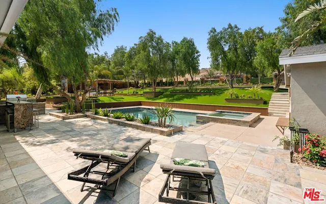 a view of a swimming pool with a patio