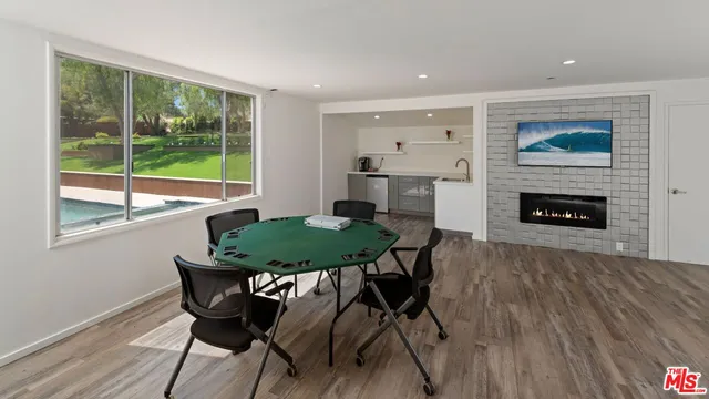 a view of a dining room with furniture and a fireplace