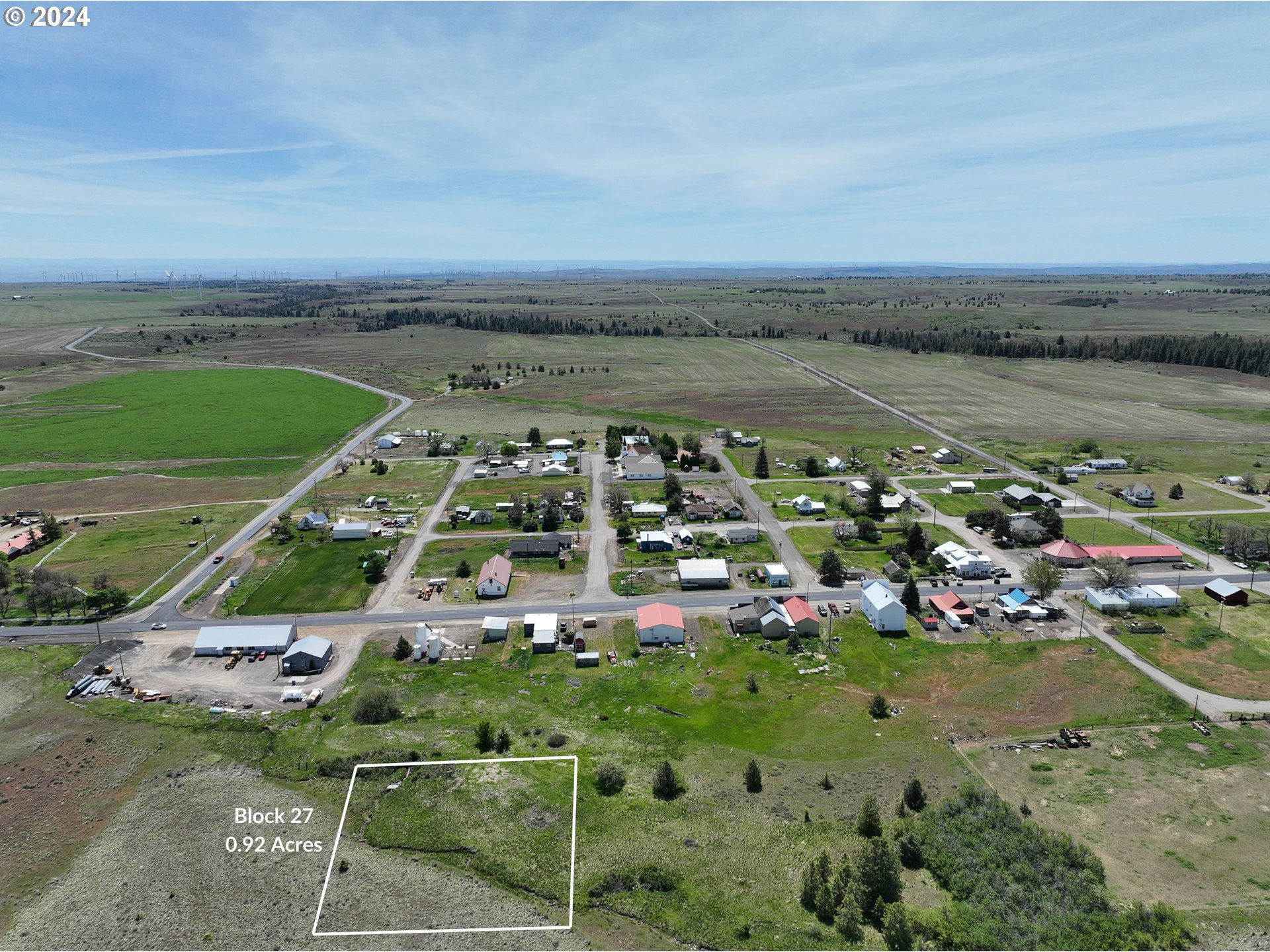 27 And 28 Bickleton, WA 99322 - Photo 2 of 12 an aerial view of a city with lots of residential buildings ocean and mountain view in back