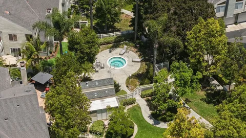 an aerial view of a house with yard swimming pool and outdoor seating