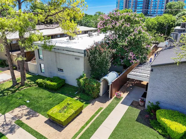 an aerial view of a house with backyard and pool