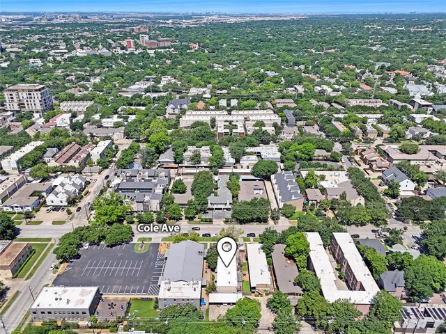 an aerial view of residential houses with city view