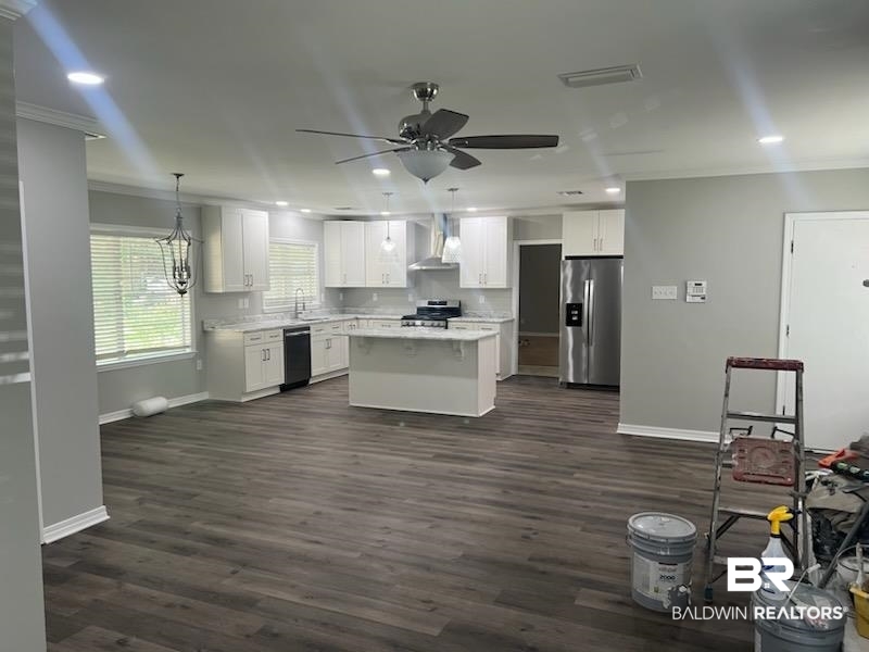 910 Cottage Hill Avenue Mobile, AL 36693 - Photo 34 of 34 Kitchen featuring range, dark wood-type flooring, a center island, decorative light fixtures, and stainless steel refrigerator with ice dispenser