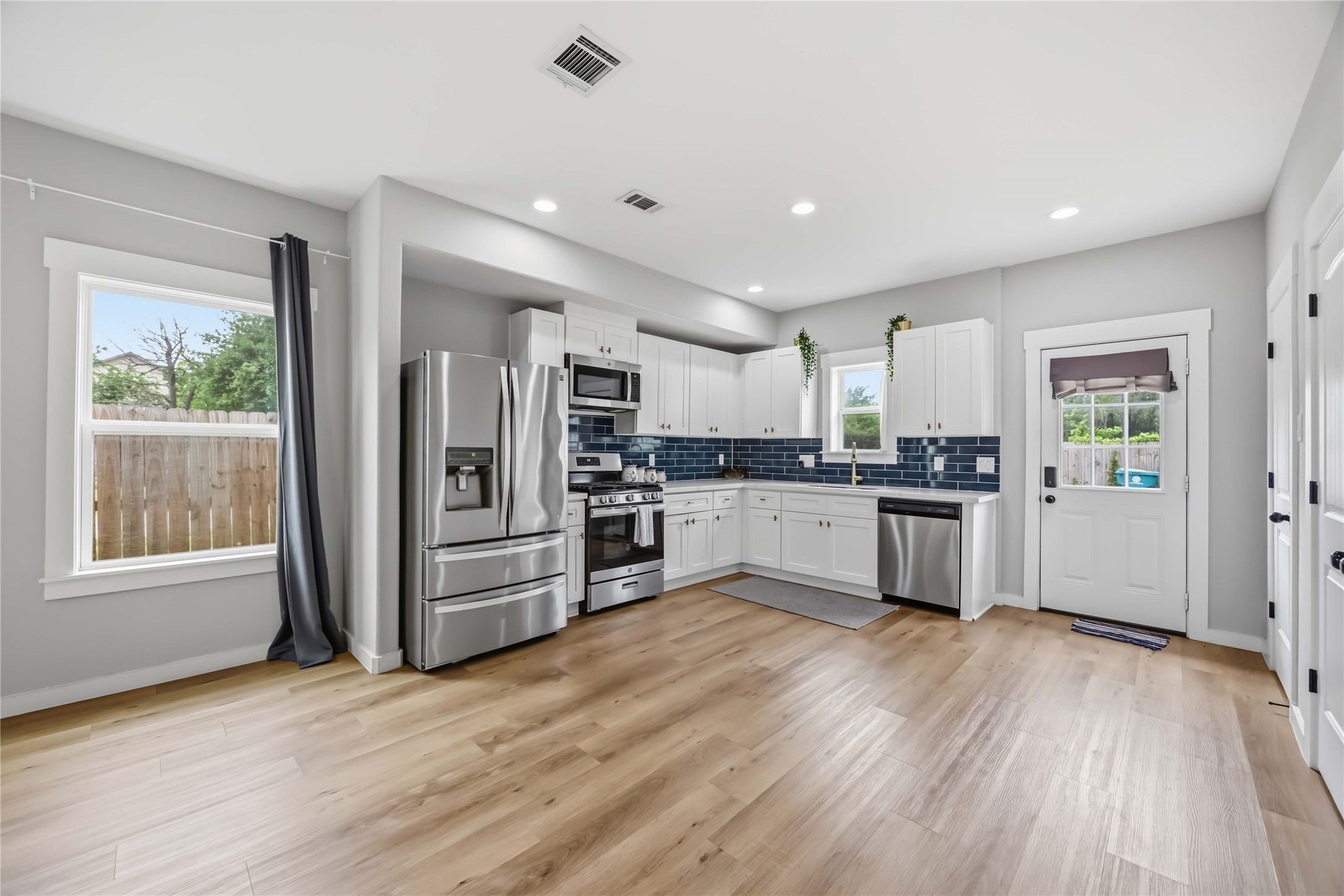 5403 Amy Street Houston, TX 77028 - Photo 10 of 28 a kitchen with granite countertop a refrigerator and wooden floor