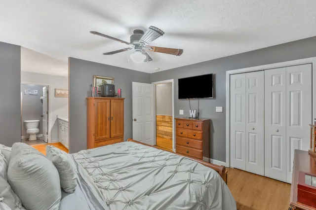 a en suite bathroom with a granite countertop double vanity sink and a mirror