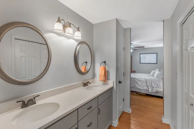 a bedroom with a bed a flat screen tv and a chandelier