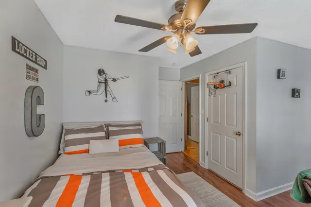 a bedroom with furniture and a wooden floor