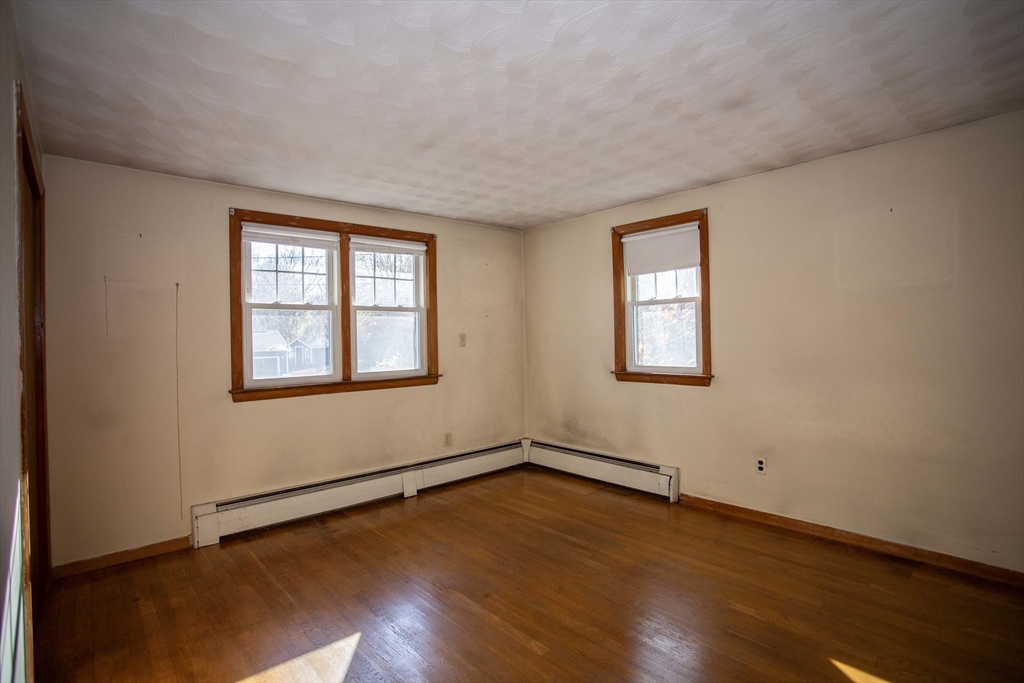 14 Sycamore Road Wakefield, MA 01880 - Photo 18 of 42 a view of an empty room with wooden floor and a window