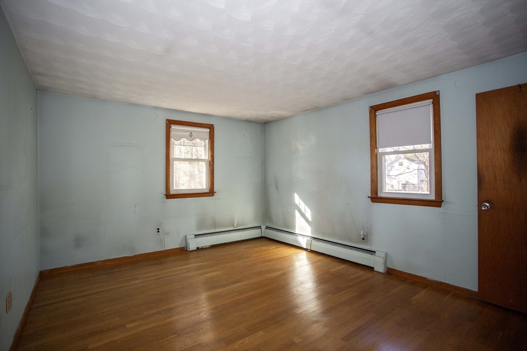 14 Sycamore Road Wakefield, MA 01880 - Photo 20 of 42 a view of an empty room with wooden floor and a window