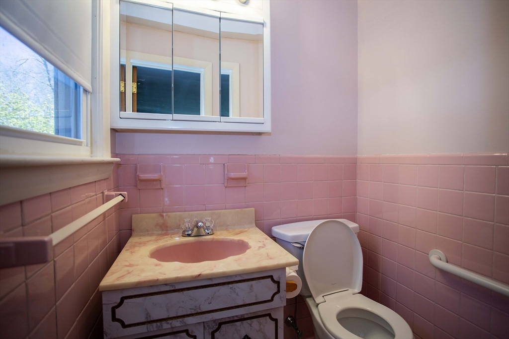 14 Sycamore Road Wakefield, MA 01880 - Photo 22 of 42 a bathroom with a toilet sink and mirror