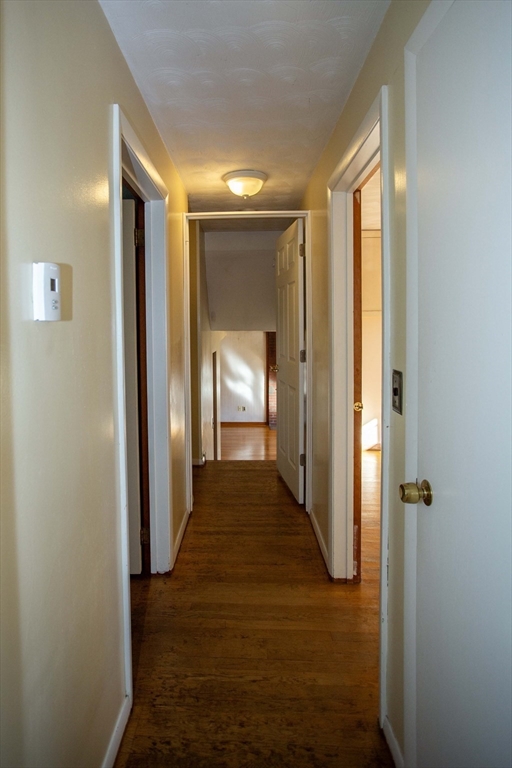 14 Sycamore Road Wakefield, MA 01880 - Photo 23 of 42 a view of a hallway with wooden floor and a bathroom
