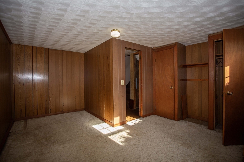 14 Sycamore Road Wakefield, MA 01880 - Photo 25 of 42 a view of livingroom with hallway and wooden shelves