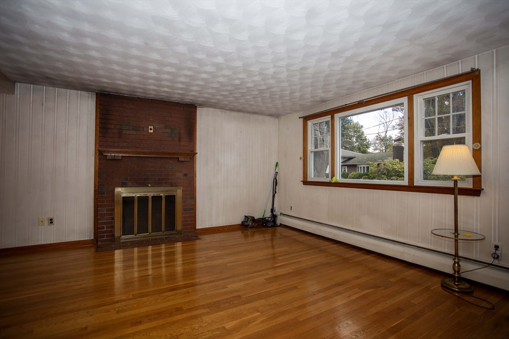 14 Sycamore Road Wakefield, MA 01880 - Photo 3 of 42 a view of a livingroom with wooden floor and a window