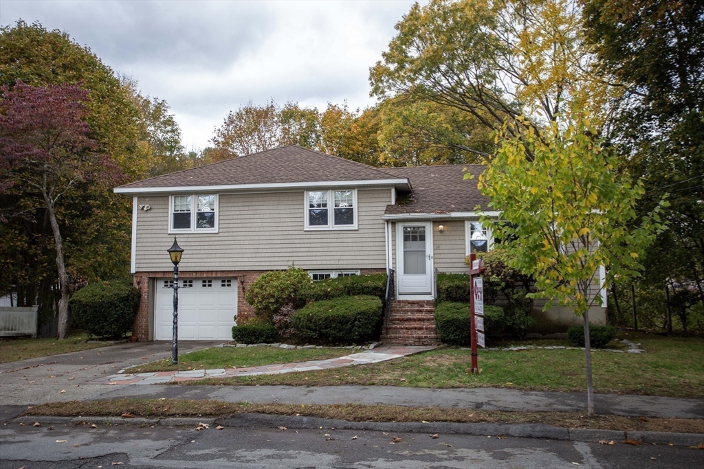 14 Sycamore Road Wakefield, MA 01880 - Photo 33 of 42 a front view of a house with a yard and garage