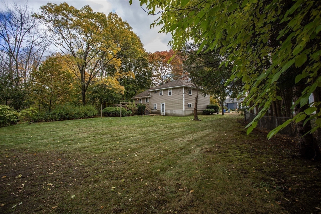 14 Sycamore Road Wakefield, MA 01880 - Photo 38 of 42 a white house with a big yard with large trees