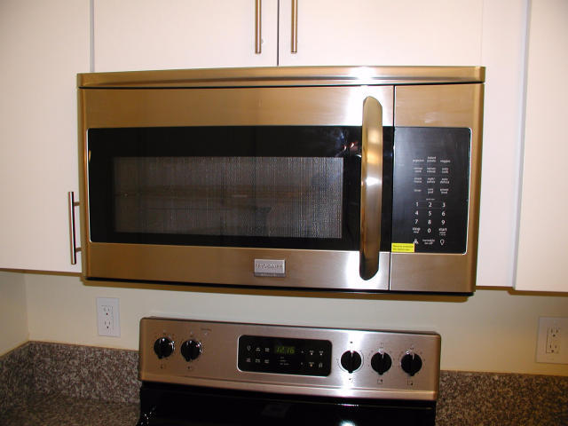 762 High Point Boulevard North, Unit D Delray Beach, FL 33445 - Photo 13 of 43 a stove top oven sitting inside of a kitchen