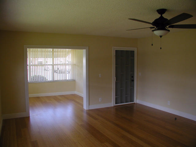 762 High Point Boulevard North, Unit D Delray Beach, FL 33445 - Photo 2 of 43 an empty room with wooden floor fan and windows