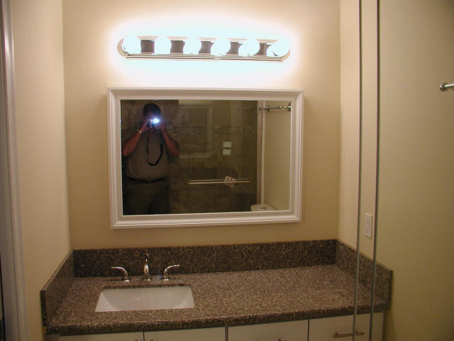 762 High Point Boulevard North, Unit D Delray Beach, FL 33445 - Photo 22 of 43 a bathroom with a sink and a mirror