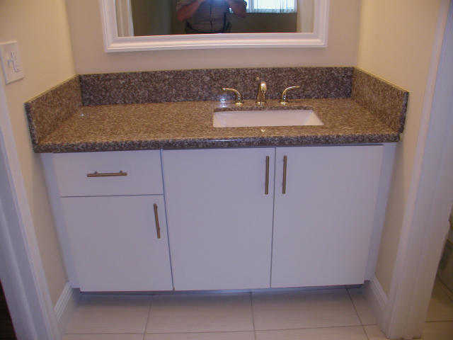762 High Point Boulevard North, Unit D Delray Beach, FL 33445 - Photo 29 of 43 a bathroom with a granite countertop sink and vanity