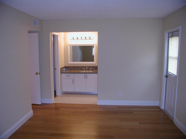 762 High Point Boulevard North, Unit D Delray Beach, FL 33445 - Photo 30 of 43 a view of washer and dryer with wooden floor