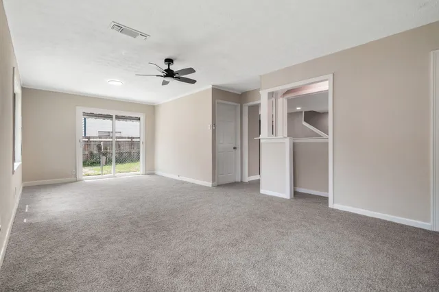 an empty room with windows and cabinet