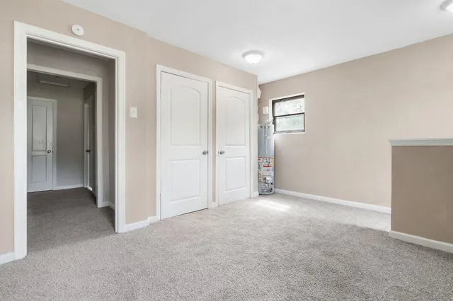 a view of an empty room and closet area