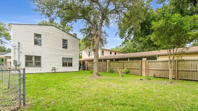 a view of a house with a yard and sitting area