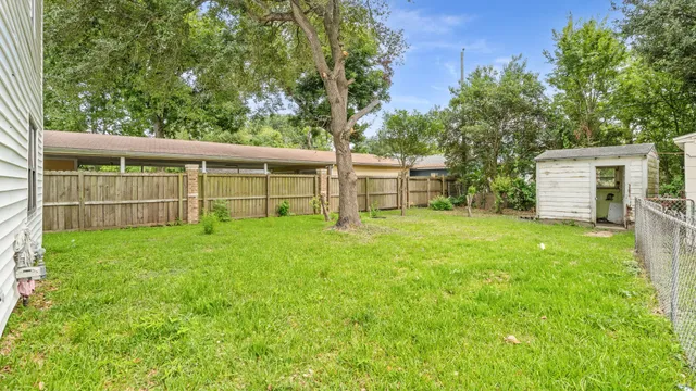 a view of a backyard with a garden and entertaining space