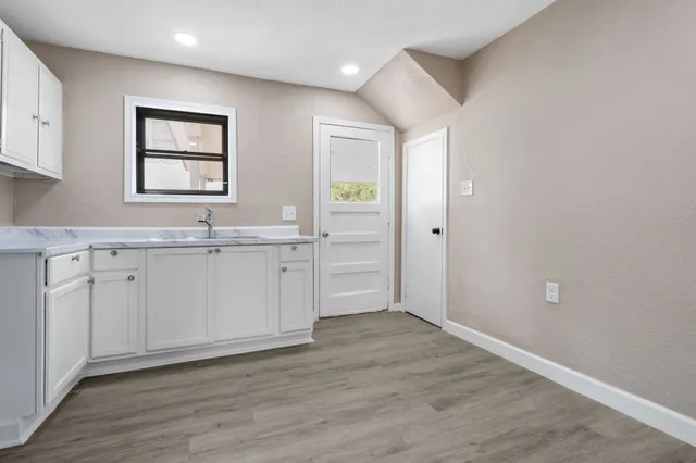 a view of a kitchen with wooden cabinet and a window