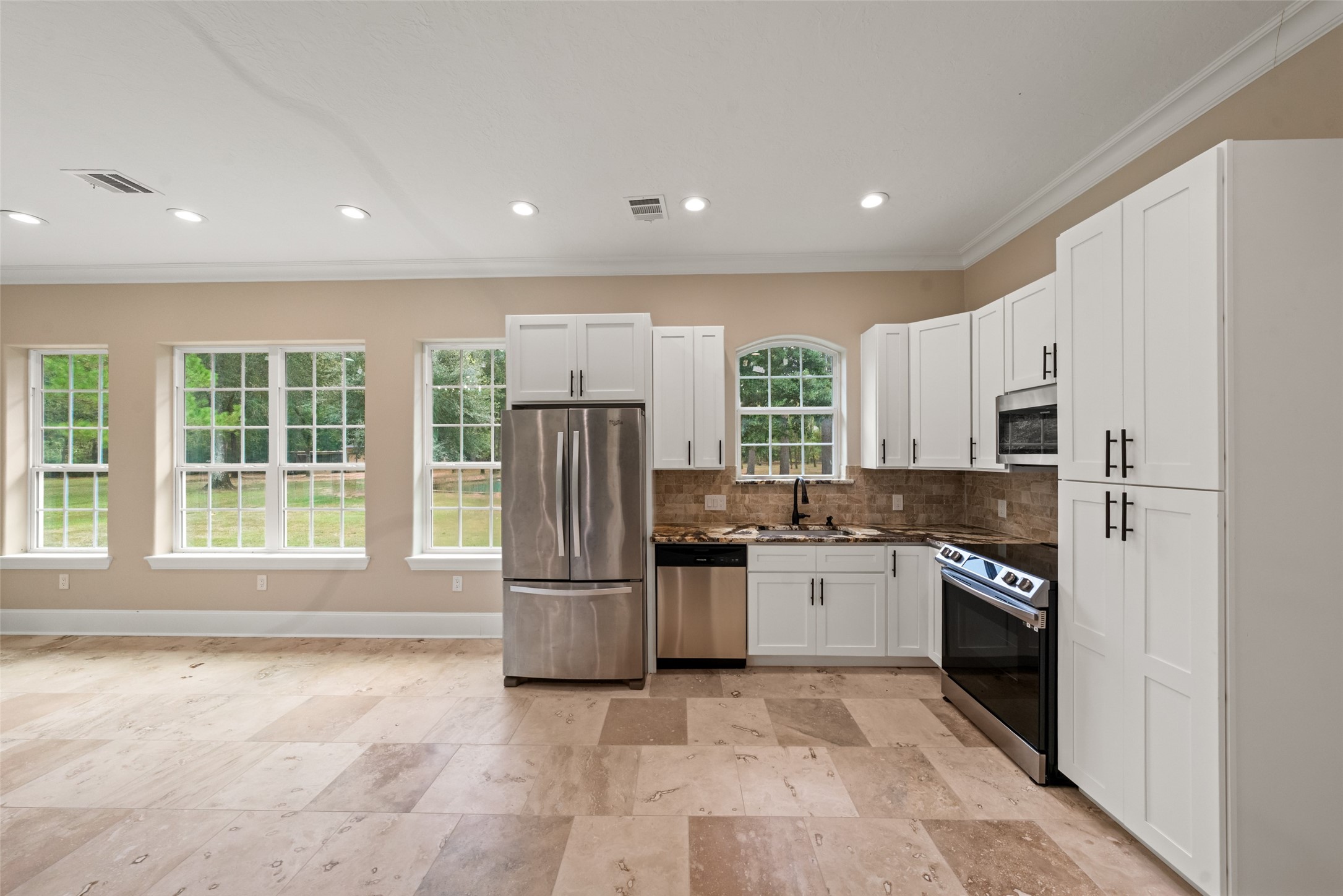 32660 Willow Bend Road Waller, TX 77484 - Photo 36 of 47 Spacious guest suite features its own kitchen with center island, abundant cabinetry, recessed lighting, and an open layout overlooking the surrounding grounds.