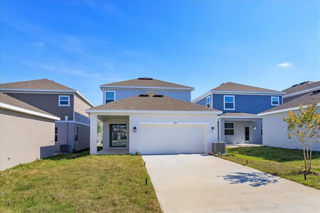 a front view of a house with a yard and garage