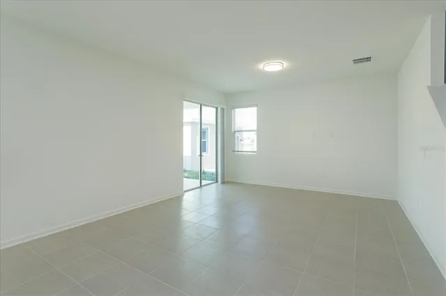 an empty room with windows and closet