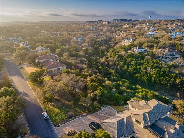 a blue swimming pool with a lake view