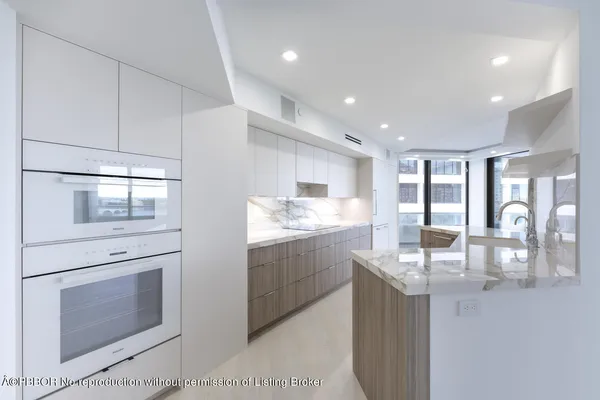 a dining room with furniture and a floor to ceiling window